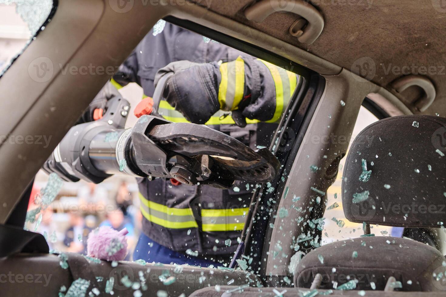 A dedicated team of professional firefighters employs specialized tools to cut and break through vehicle wreckage, showcasing their skilled collaboration and swift response in rescuing individuals photo