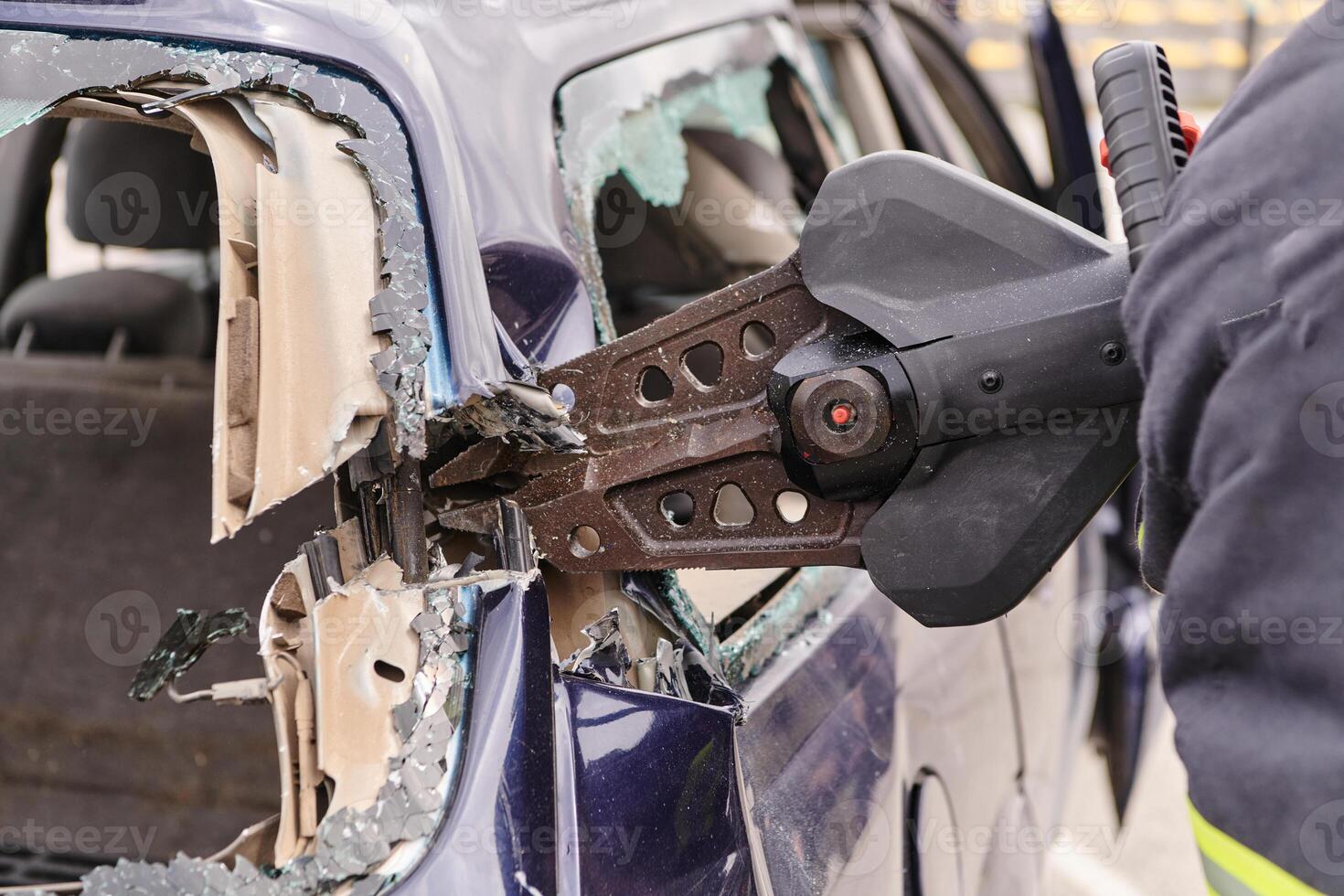 A dedicated team of professional firefighters employs specialized tools to cut and break through vehicle wreckage, showcasing their skilled collaboration and swift response in rescuing individuals photo