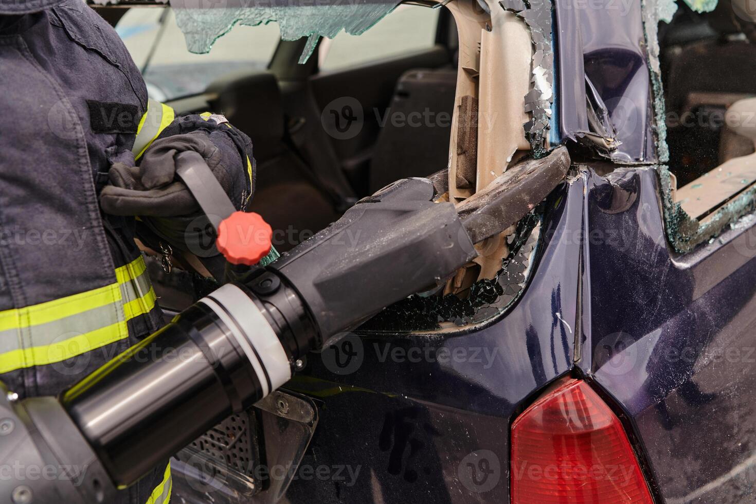 A dedicated team of professional firefighters employs specialized tools to cut and break through vehicle wreckage, showcasing their skilled collaboration and swift response in rescuing individuals photo