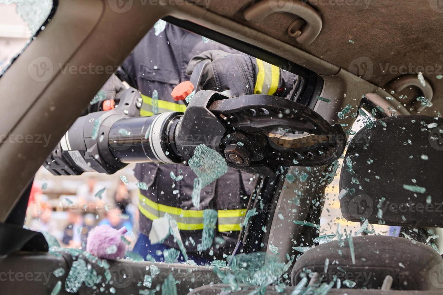 A dedicated team of professional firefighters employs specialized tools to cut and break through vehicle wreckage, showcasing their skilled collaboration and swift response in rescuing individuals photo