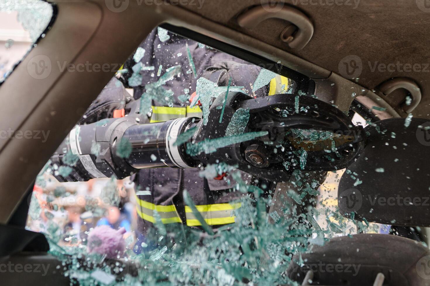 A dedicated team of professional firefighters employs specialized tools to cut and break through vehicle wreckage, showcasing their skilled collaboration and swift response in rescuing individuals photo