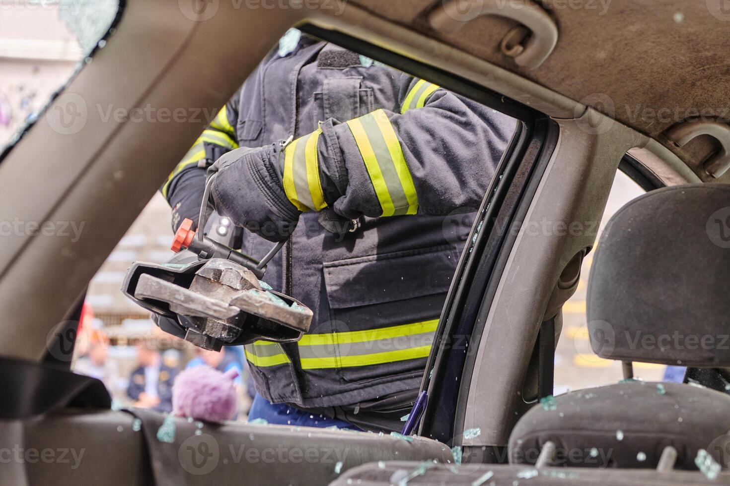 A dedicated team of professional firefighters employs specialized tools to cut and break through vehicle wreckage, showcasing their skilled collaboration and swift response in rescuing individuals photo