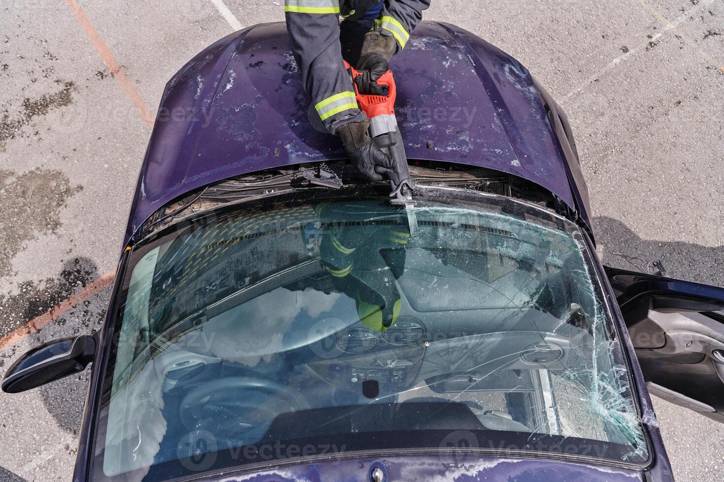 A dedicated team of professional firefighters employs specialized tools to cut and break through vehicle wreckage, showcasing their skilled collaboration and swift response in rescuing individuals photo