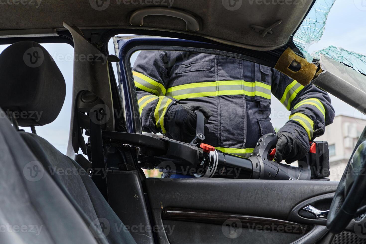 A dedicated team of professional firefighters employs specialized tools to cut and break through vehicle wreckage, showcasing their skilled collaboration and swift response in rescuing individuals photo