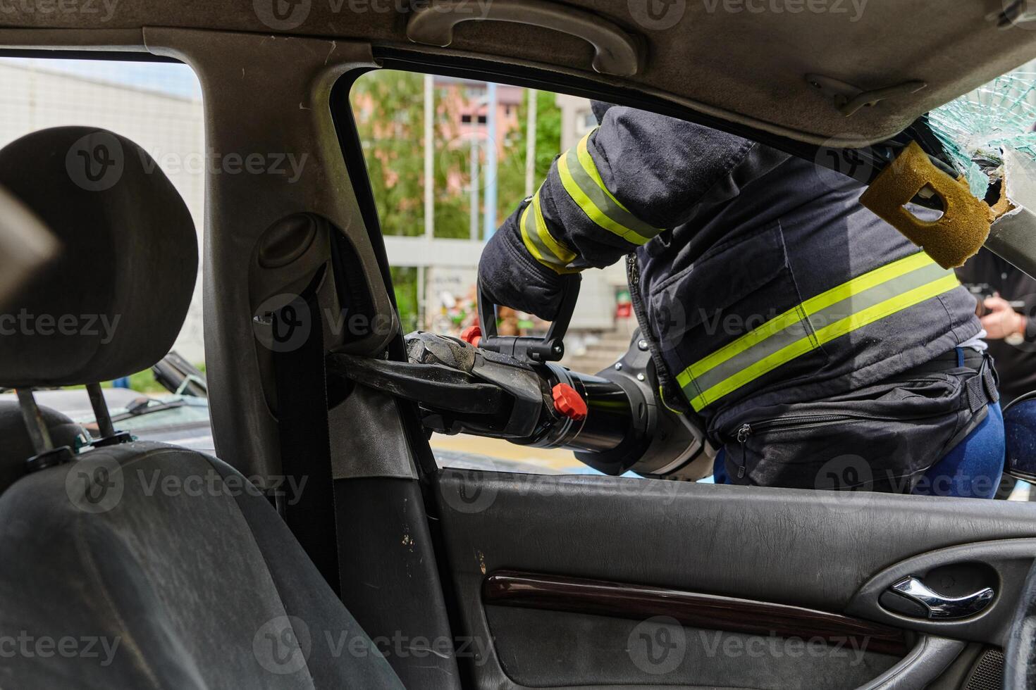 A dedicated team of professional firefighters employs specialized tools to cut and break through vehicle wreckage, showcasing their skilled collaboration and swift response in rescuing individuals photo