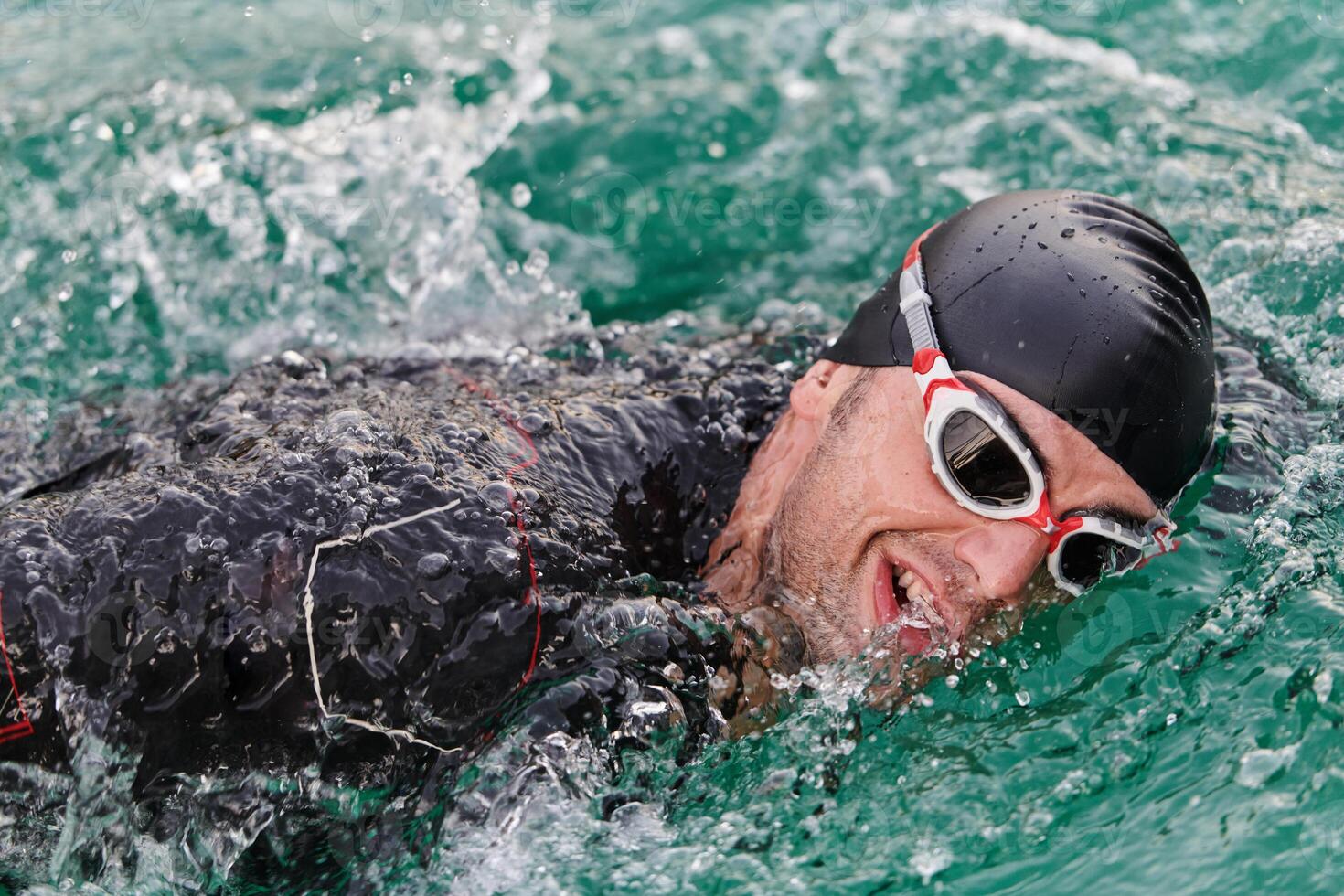 A professional triathlete trains with unwavering dedication for an upcoming competition at a lake, emanating a sense of athleticism and profound commitment to excellence. photo