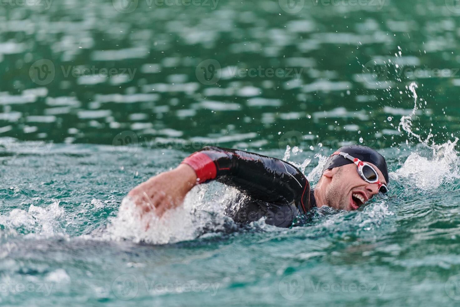 A professional triathlete trains with unwavering dedication for an upcoming competition at a lake, emanating a sense of athleticism and profound commitment to excellence. photo