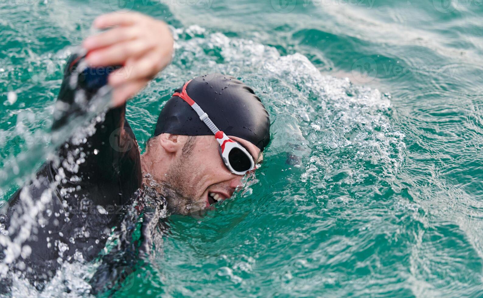 A professional triathlete trains with unwavering dedication for an upcoming competition at a lake, emanating a sense of athleticism and profound commitment to excellence. photo