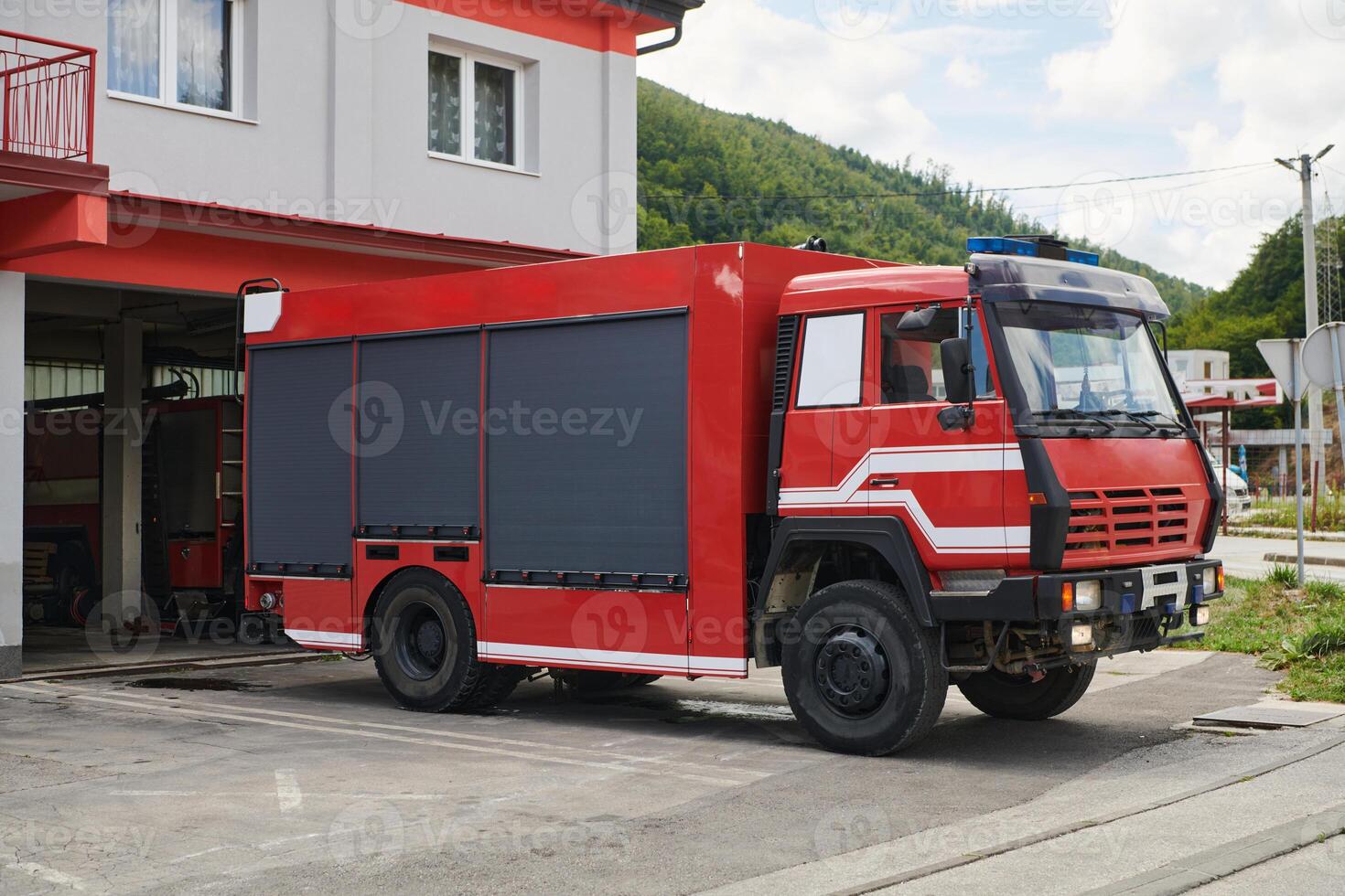 A state-of-the-art firetruck, equipped with advanced rescue technology, stands ready with its skilled firefighting team, prepared to intervene and respond rapidly to emergencies, ensuring the safety photo