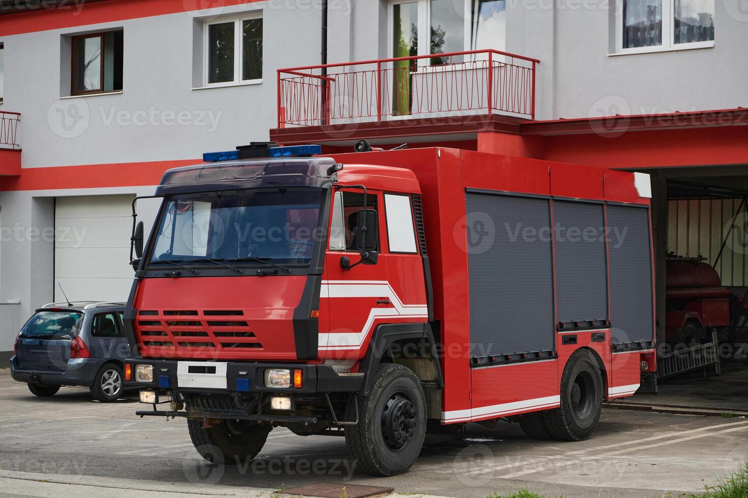 A state-of-the-art firetruck, equipped with advanced rescue technology, stands ready with its skilled firefighting team, prepared to intervene and respond rapidly to emergencies, ensuring the safety photo