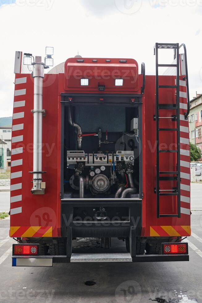 A state-of-the-art firetruck, equipped with advanced rescue technology, stands ready with its skilled firefighting team, prepared to intervene and respond rapidly to emergencies, ensuring the safety photo