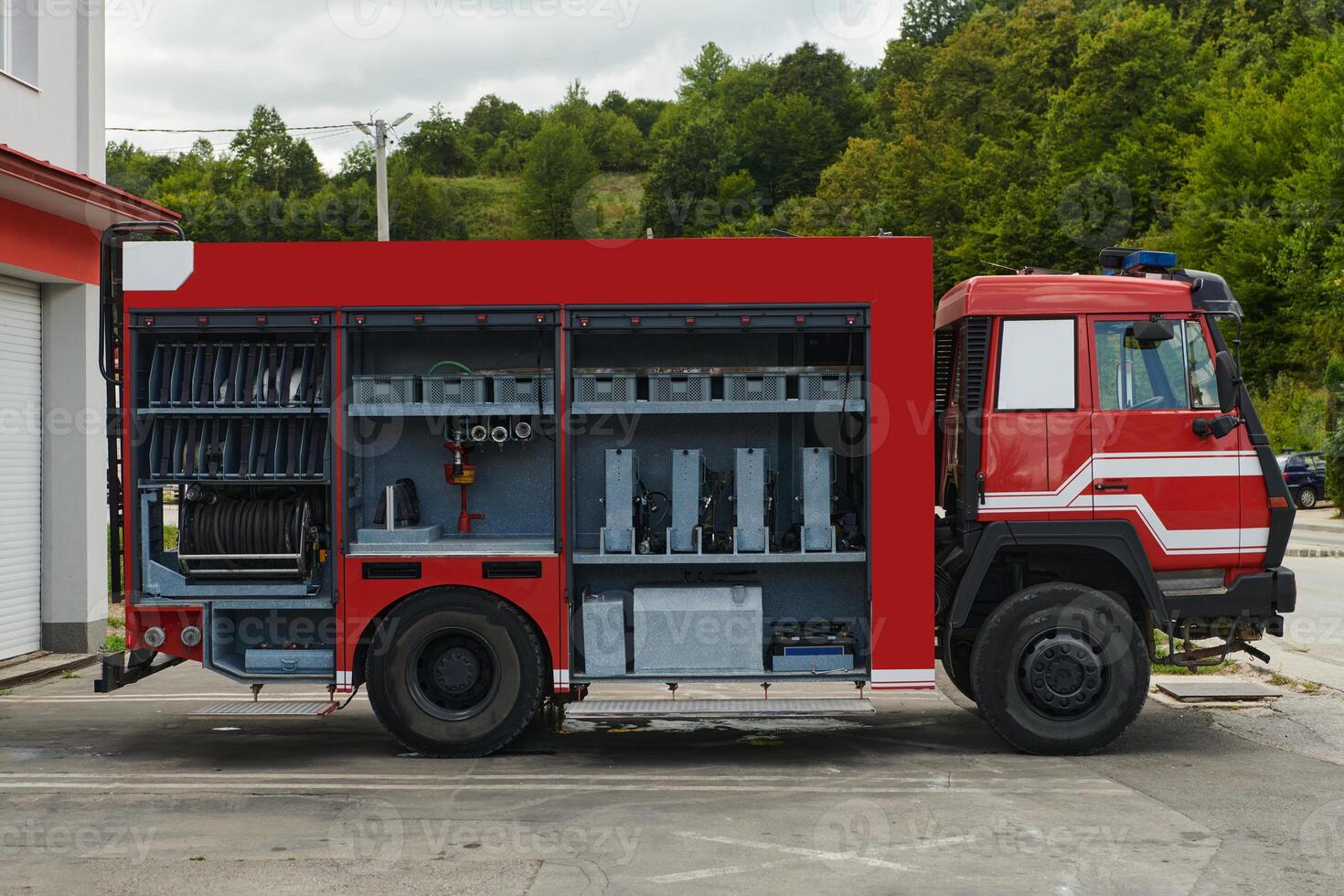 A state-of-the-art firetruck, equipped with advanced rescue technology, stands ready with its skilled firefighting team, prepared to intervene and respond rapidly to emergencies, ensuring the safety photo