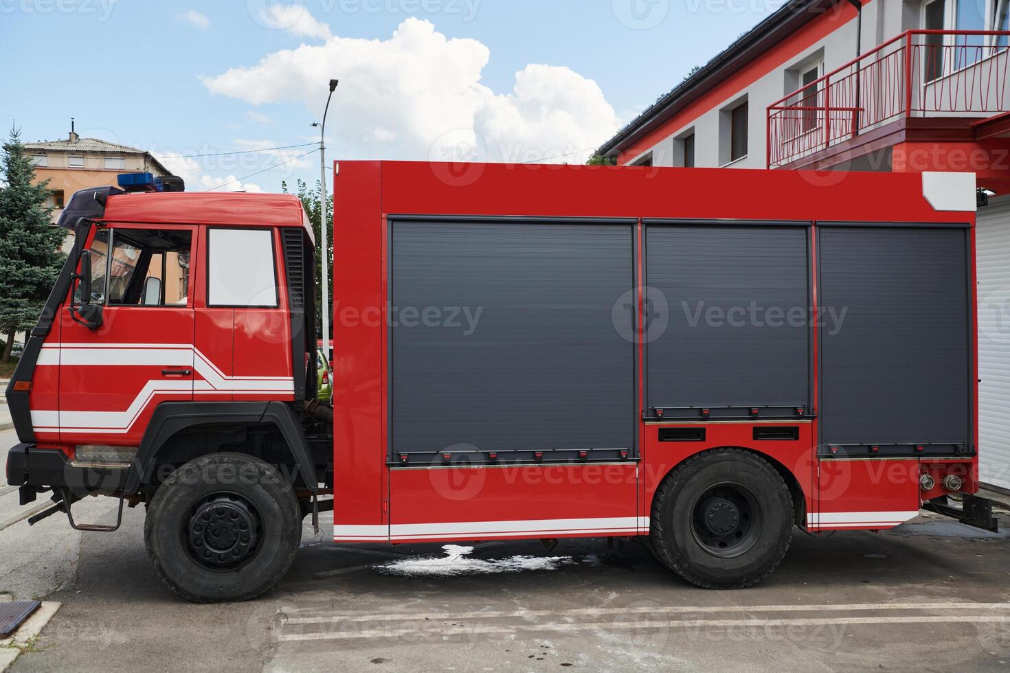 A state-of-the-art firetruck, equipped with advanced rescue technology, stands ready with its skilled firefighting team, prepared to intervene and respond rapidly to emergencies, ensuring the safety photo
