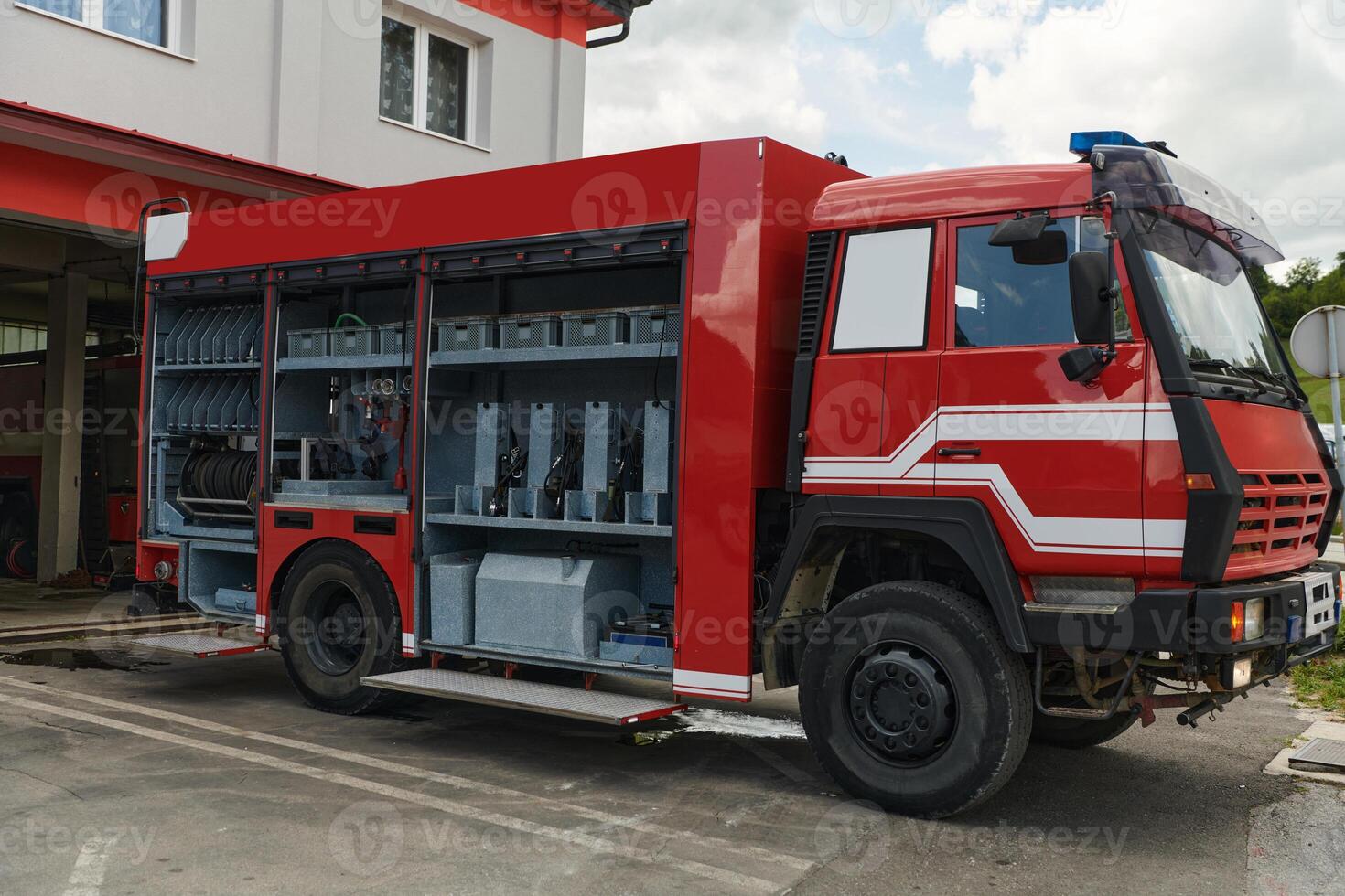 A state-of-the-art firetruck, equipped with advanced rescue technology, stands ready with its skilled firefighting team, prepared to intervene and respond rapidly to emergencies, ensuring the safety photo