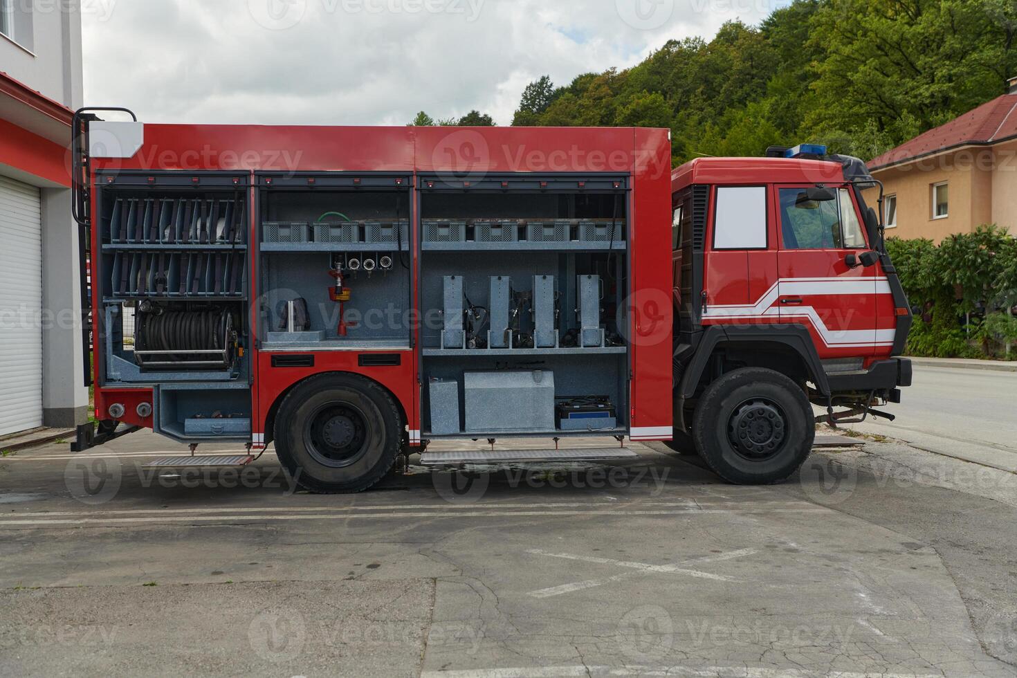 A state-of-the-art firetruck, equipped with advanced rescue technology, stands ready with its skilled firefighting team, prepared to intervene and respond rapidly to emergencies, ensuring the safety photo