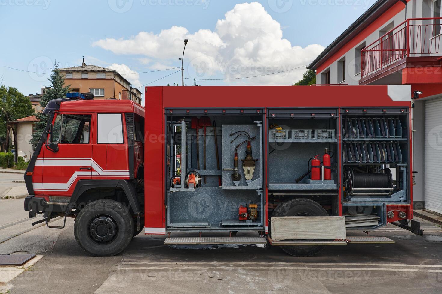 A state-of-the-art firetruck, equipped with advanced rescue technology, stands ready with its skilled firefighting team, prepared to intervene and respond rapidly to emergencies, ensuring the safety photo