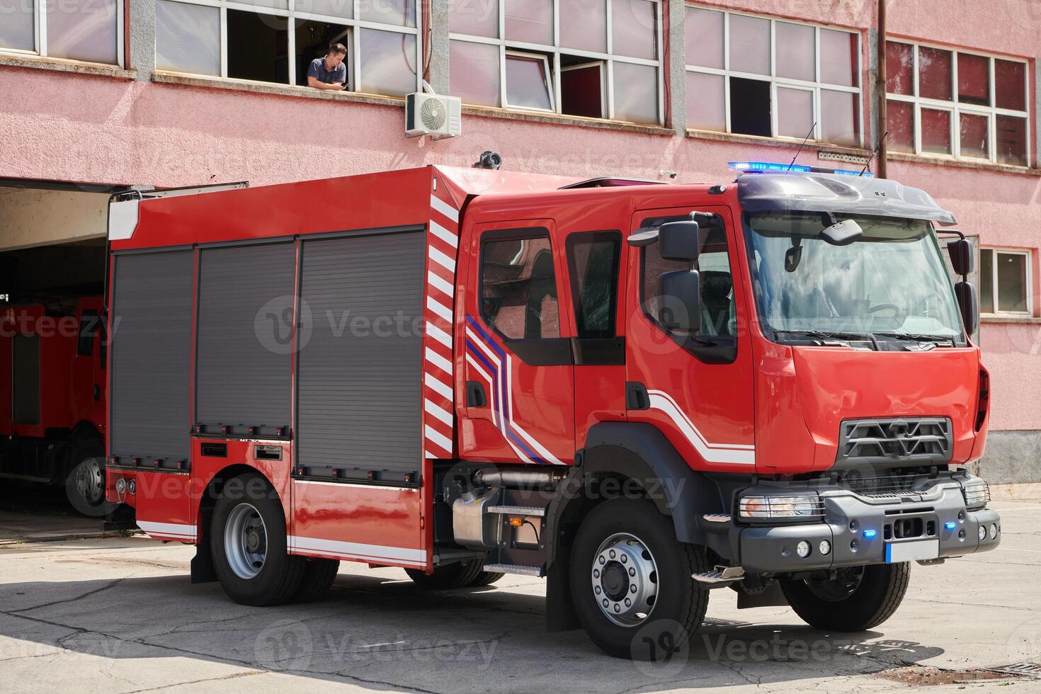 A state-of-the-art firetruck, equipped with advanced rescue technology, stands ready with its skilled firefighting team, prepared to intervene and respond rapidly to emergencies, ensuring the safety photo