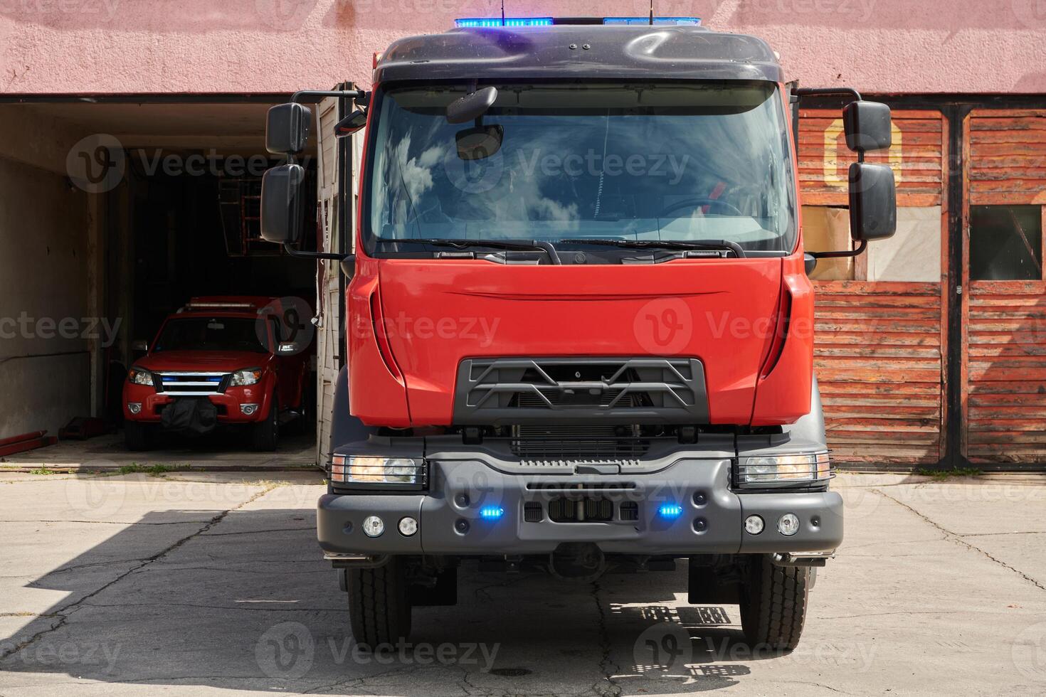 A state-of-the-art firetruck, equipped with advanced rescue technology, stands ready with its skilled firefighting team, prepared to intervene and respond rapidly to emergencies, ensuring the safety photo