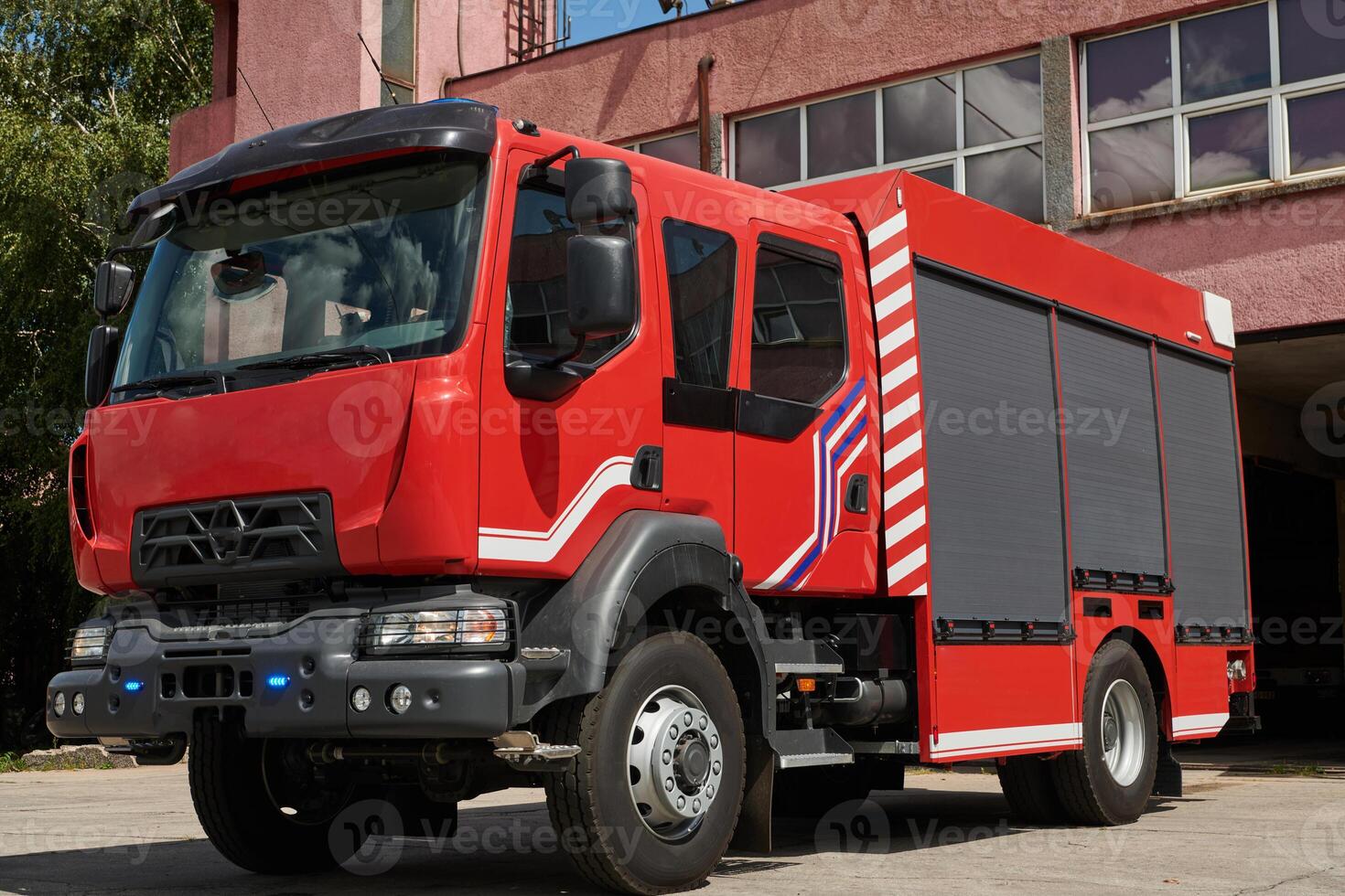 A state-of-the-art firetruck, equipped with advanced rescue technology, stands ready with its skilled firefighting team, prepared to intervene and respond rapidly to emergencies, ensuring the safety photo