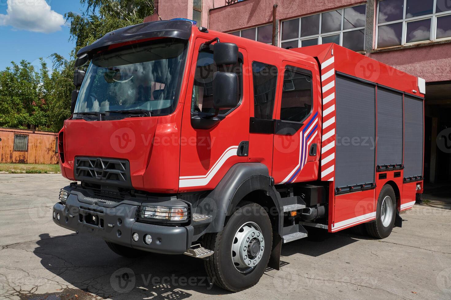 A state-of-the-art firetruck, equipped with advanced rescue technology, stands ready with its skilled firefighting team, prepared to intervene and respond rapidly to emergencies, ensuring the safety photo