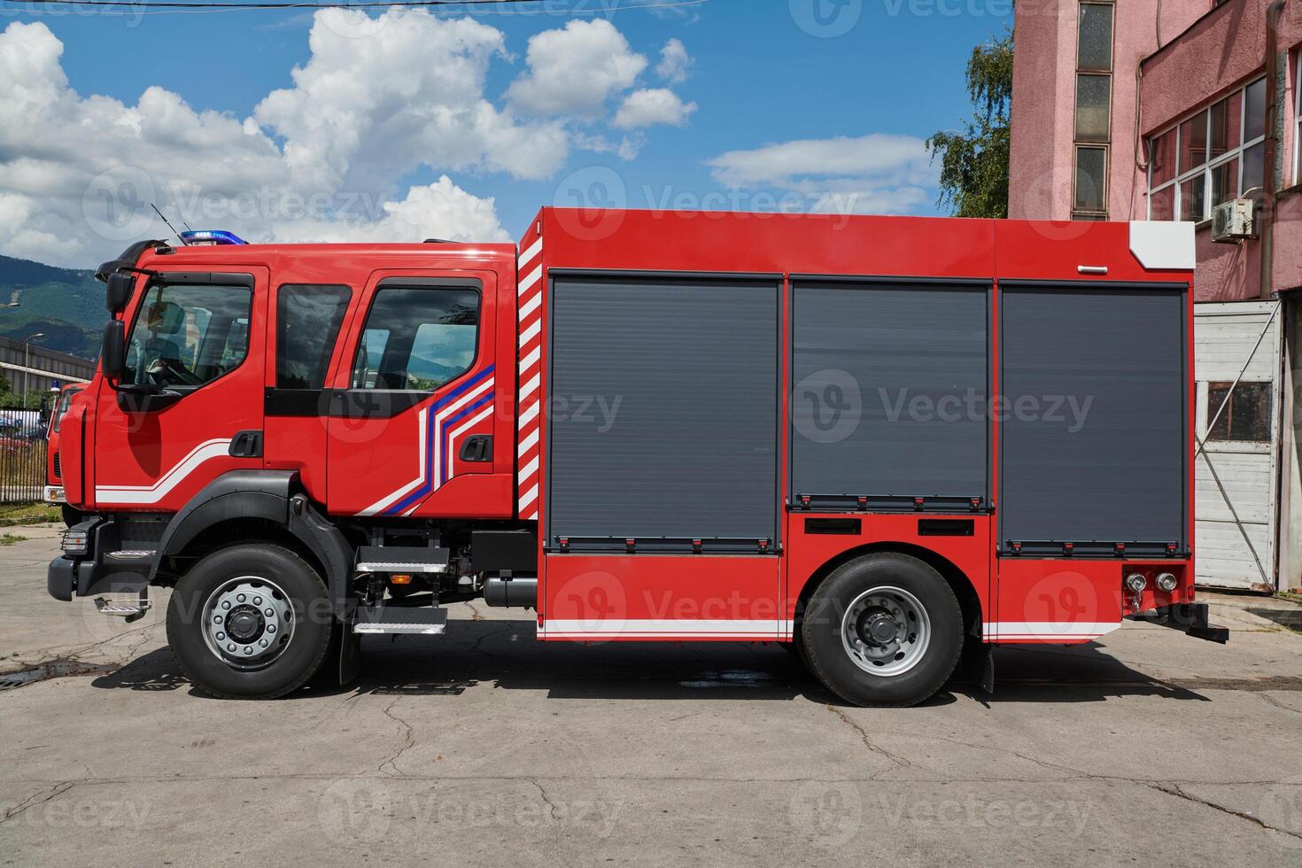 A state-of-the-art firetruck, equipped with advanced rescue technology, stands ready with its skilled firefighting team, prepared to intervene and respond rapidly to emergencies, ensuring the safety photo