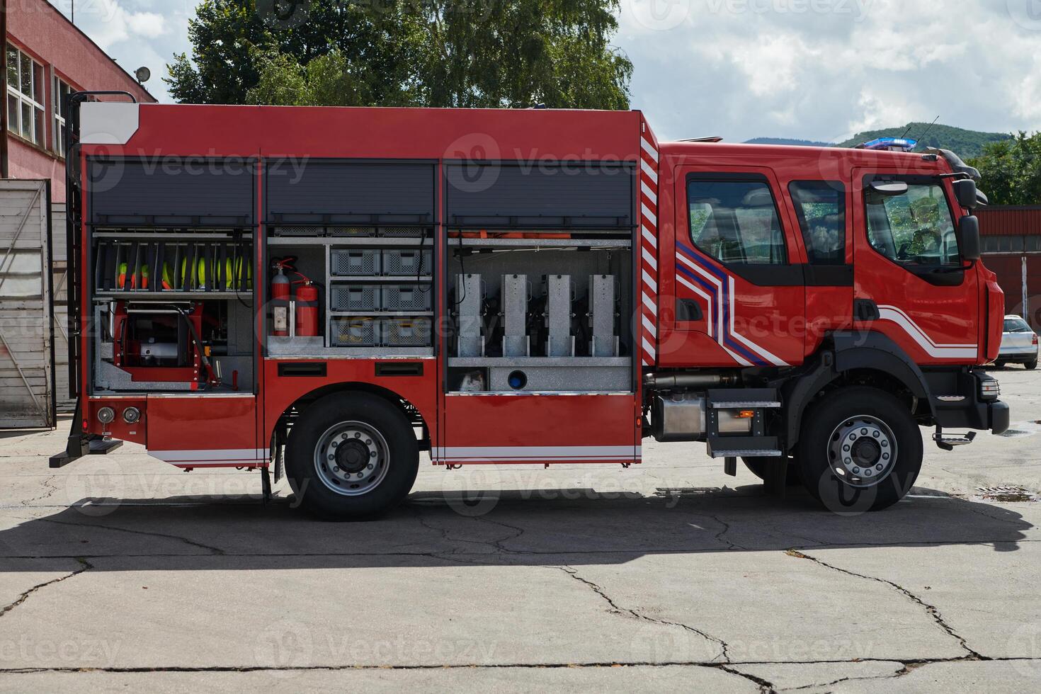 A state-of-the-art firetruck, equipped with advanced rescue technology, stands ready with its skilled firefighting team, prepared to intervene and respond rapidly to emergencies, ensuring the safety photo
