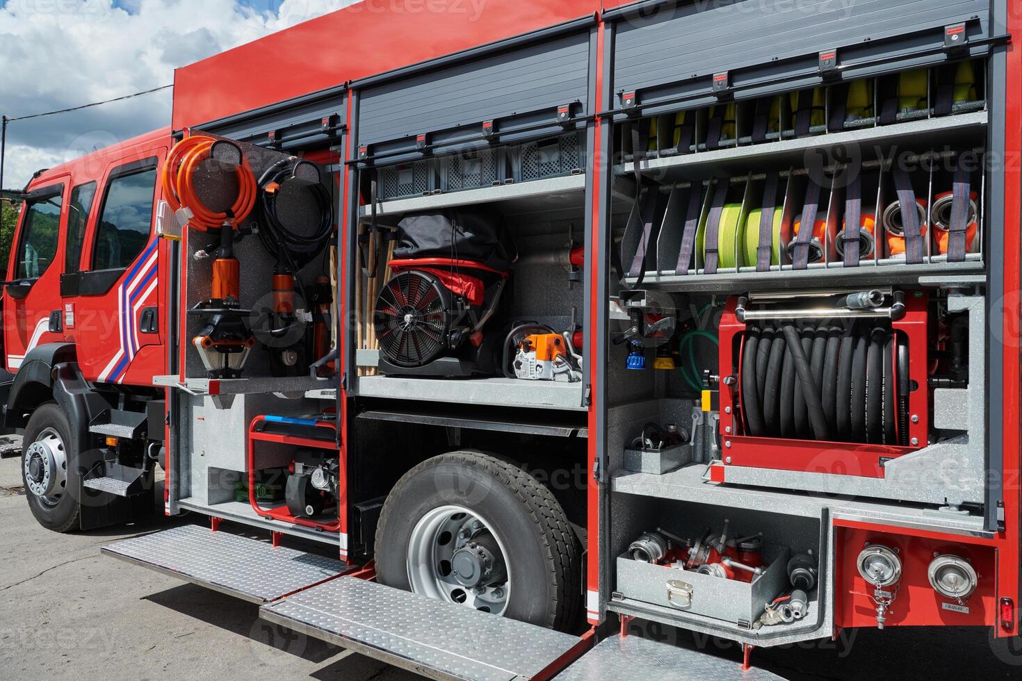 A state-of-the-art firetruck, equipped with advanced rescue technology, stands ready with its skilled firefighting team, prepared to intervene and respond rapidly to emergencies, ensuring the safety photo