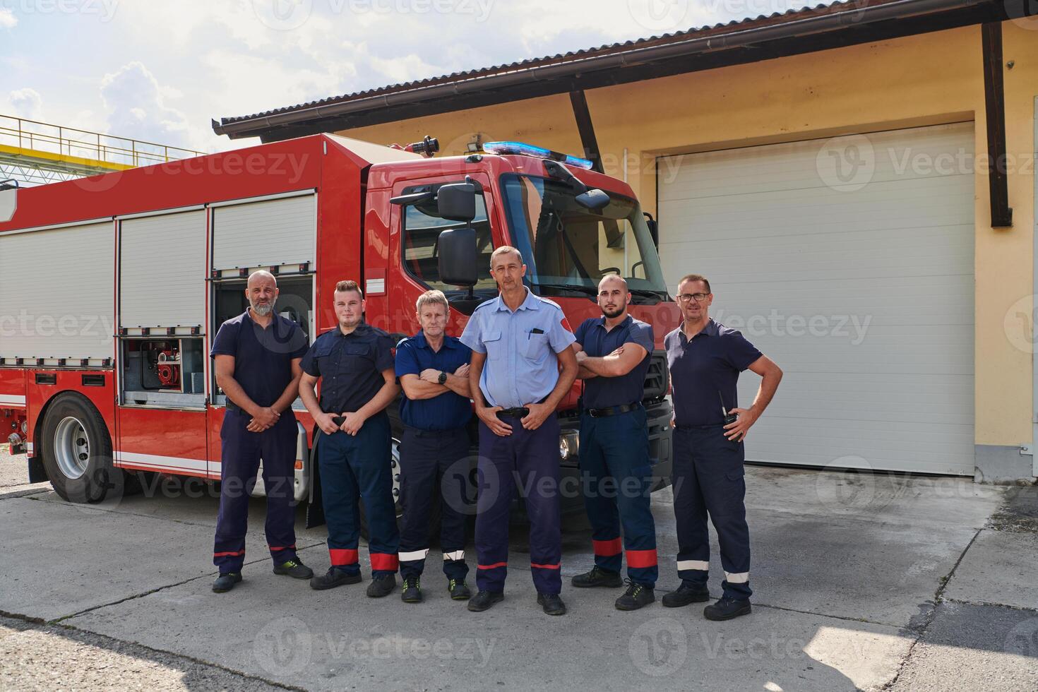 A skilled and dedicated professional firefighting team proudly poses in front of their state of the art firetruck, showcasing their modern equipment and commitment to ensuring public safety. photo
