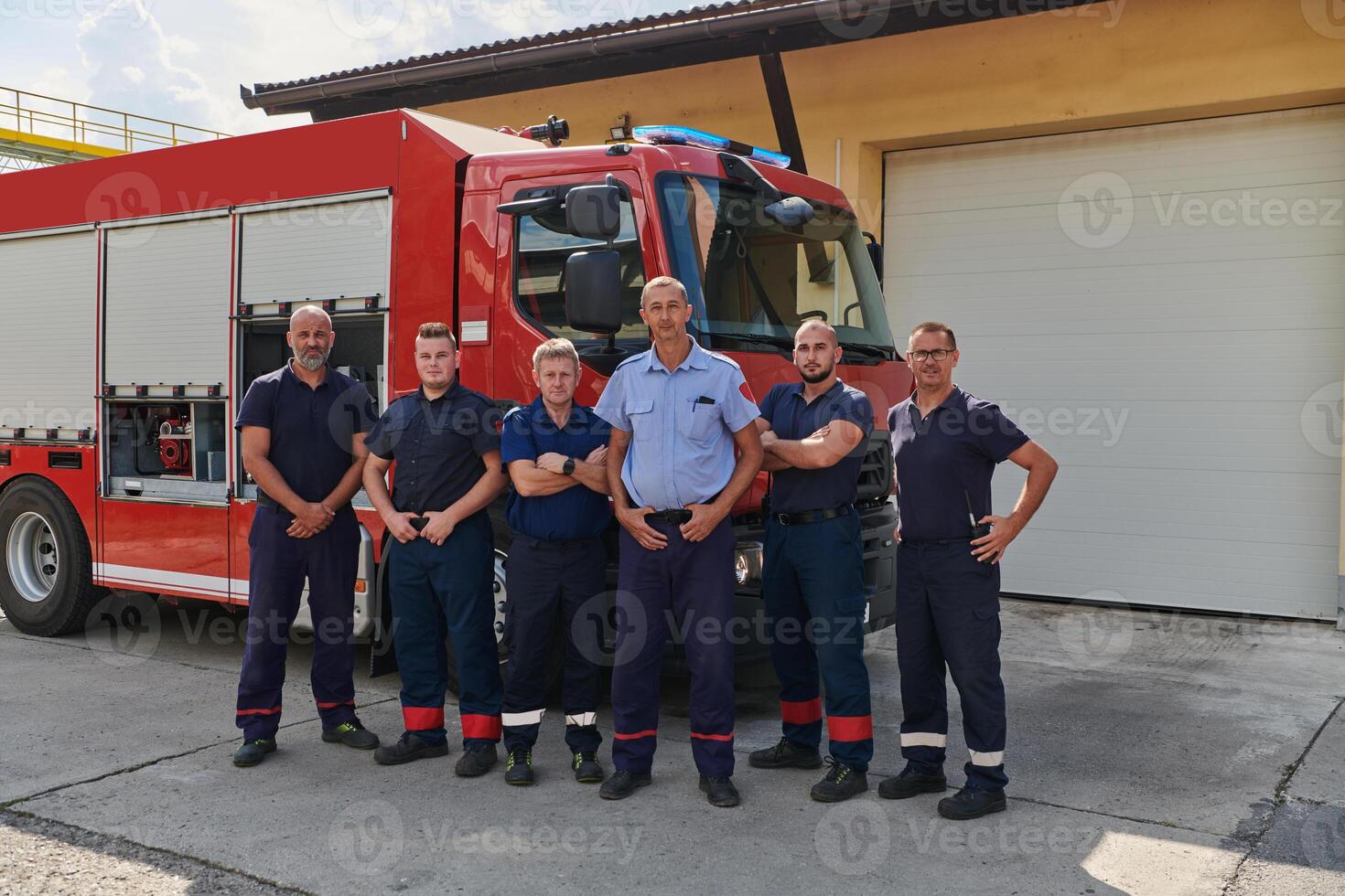 A skilled and dedicated professional firefighting team proudly poses in front of their state of the art firetruck, showcasing their modern equipment and commitment to ensuring public safety. photo