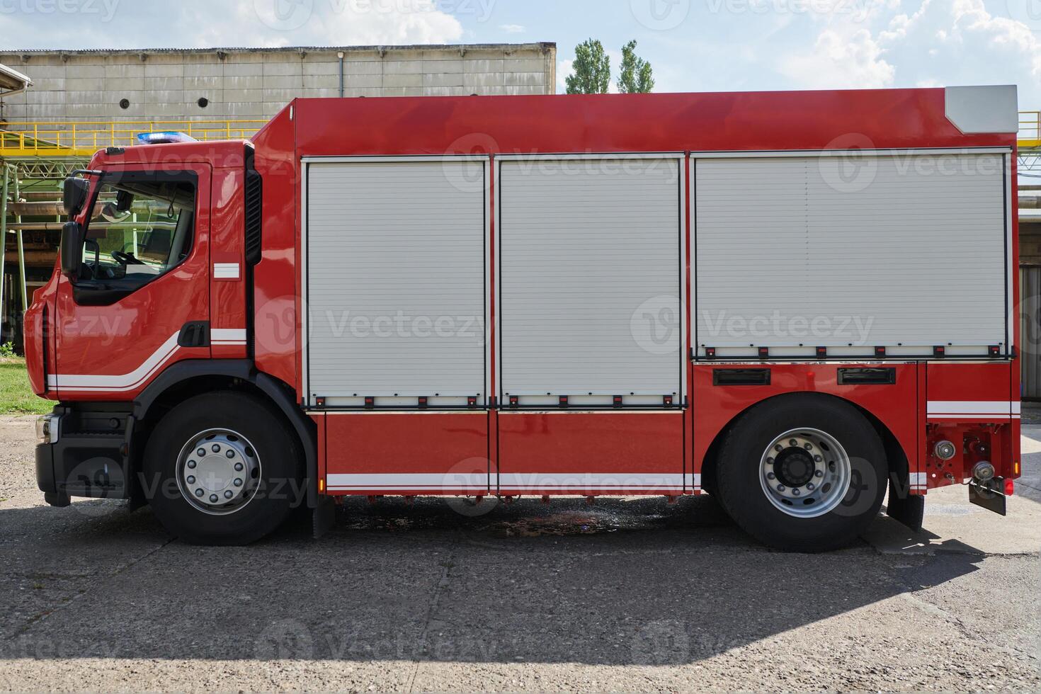 A state-of-the-art firetruck, equipped with advanced rescue technology, stands ready with its skilled firefighting team, prepared to intervene and respond rapidly to emergencies, ensuring the safety photo