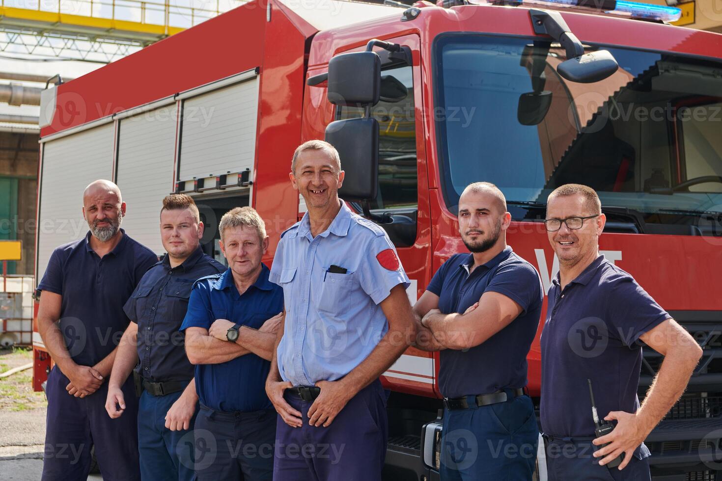 A skilled and dedicated professional firefighting team proudly poses in front of their state of the art firetruck, showcasing their modern equipment and commitment to ensuring public safety. photo