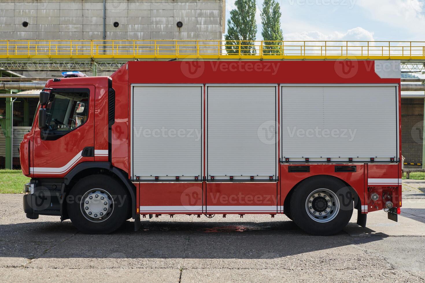 A state-of-the-art firetruck, equipped with advanced rescue technology, stands ready with its skilled firefighting team, prepared to intervene and respond rapidly to emergencies, ensuring the safety photo