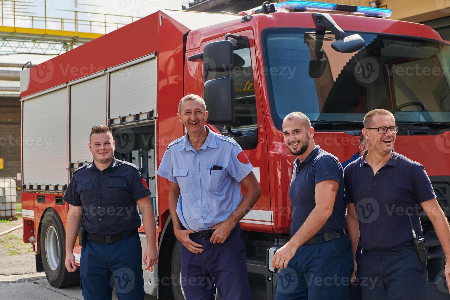A skilled and dedicated professional firefighting team proudly poses in front of their state of the art firetruck, showcasing their modern equipment and commitment to ensuring public safety. photo
