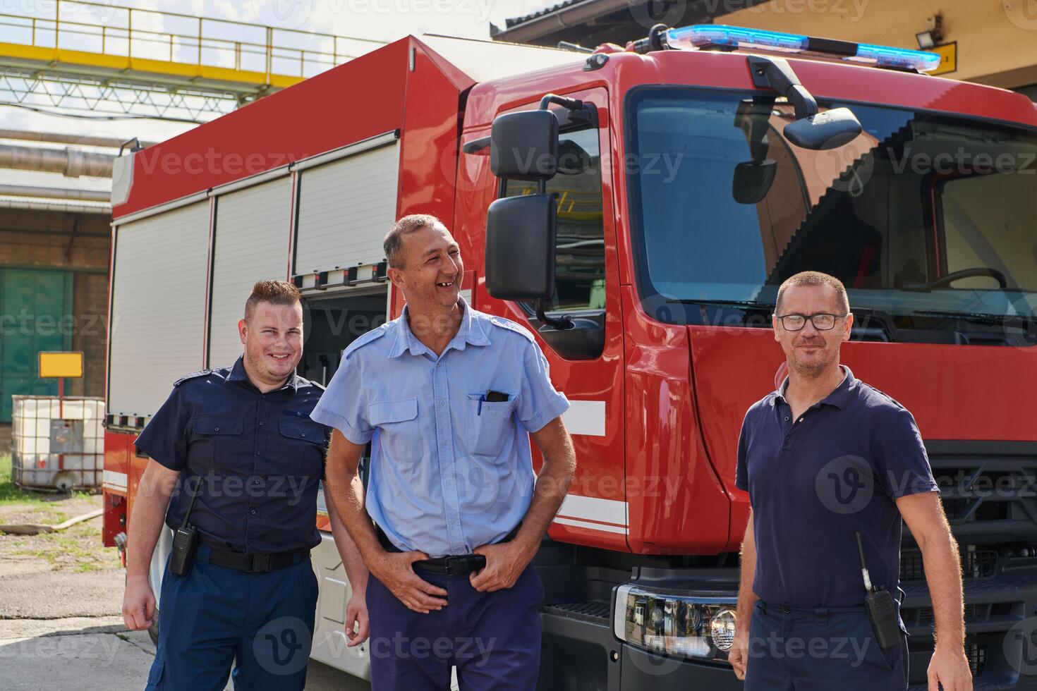 A skilled and dedicated professional firefighting team proudly poses in front of their state of the art firetruck, showcasing their modern equipment and commitment to ensuring public safety. photo