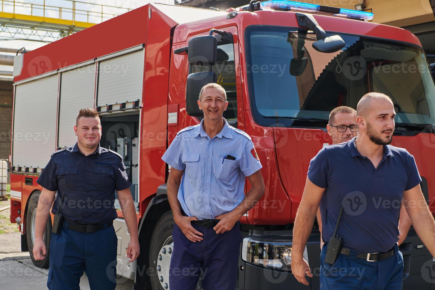 A skilled and dedicated professional firefighting team proudly poses in front of their state of the art firetruck, showcasing their modern equipment and commitment to ensuring public safety. photo
