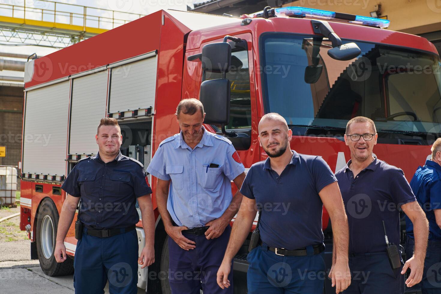 A skilled and dedicated professional firefighting team proudly poses in front of their state of the art firetruck, showcasing their modern equipment and commitment to ensuring public safety. photo