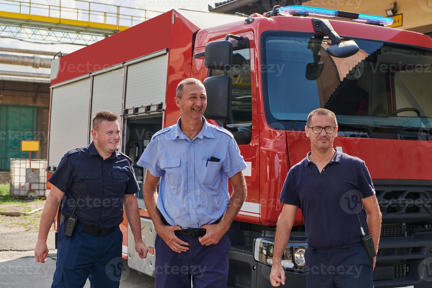 A skilled and dedicated professional firefighting team proudly poses in front of their state of the art firetruck, showcasing their modern equipment and commitment to ensuring public safety. photo
