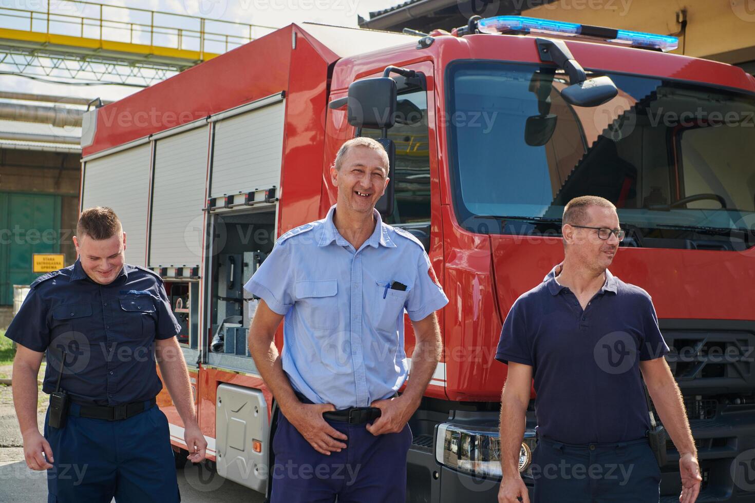 A skilled and dedicated professional firefighting team proudly poses in front of their state of the art firetruck, showcasing their modern equipment and commitment to ensuring public safety. photo