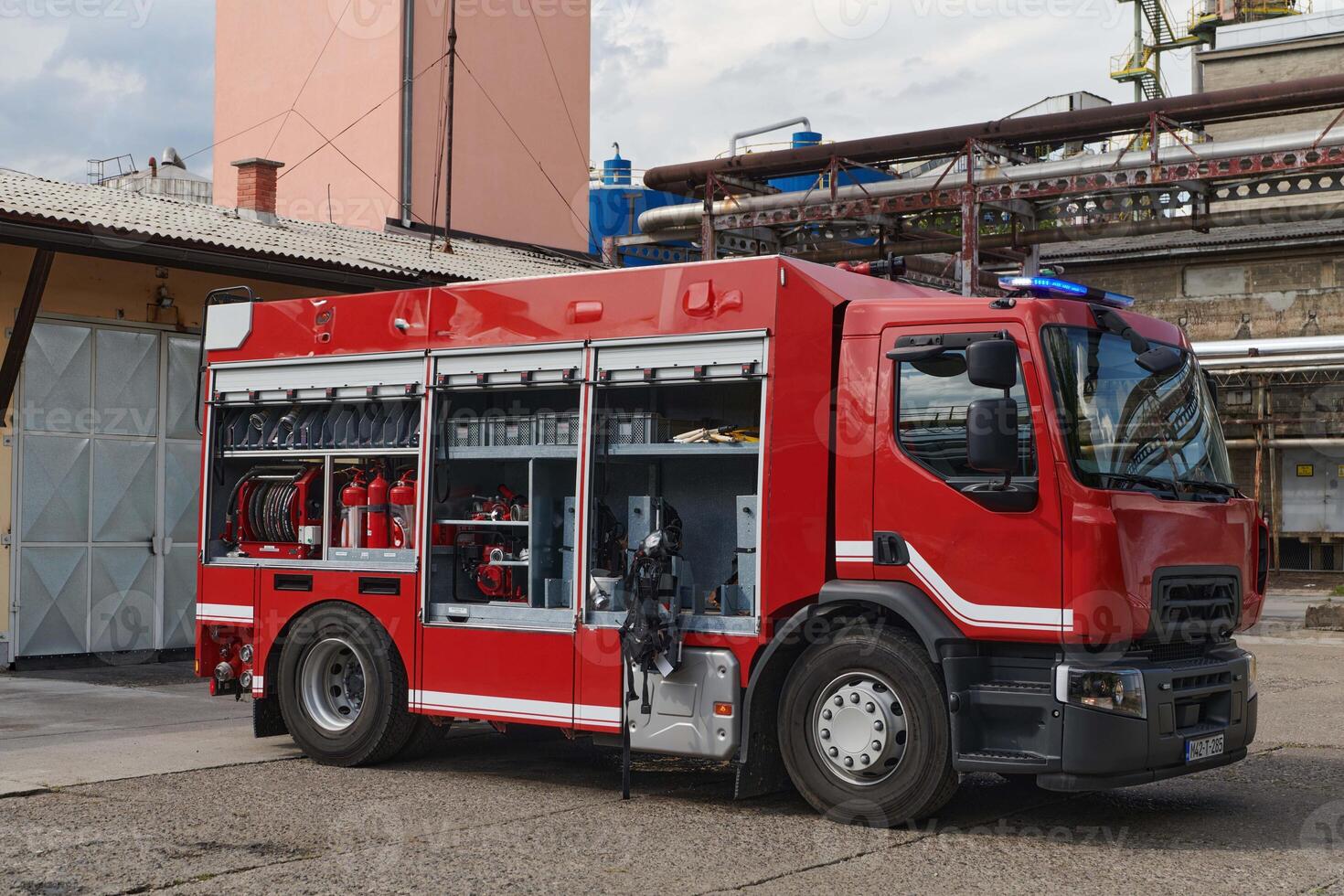 A state-of-the-art firetruck, equipped with advanced rescue technology, stands ready with its skilled firefighting team, prepared to intervene and respond rapidly to emergencies, ensuring the safety photo