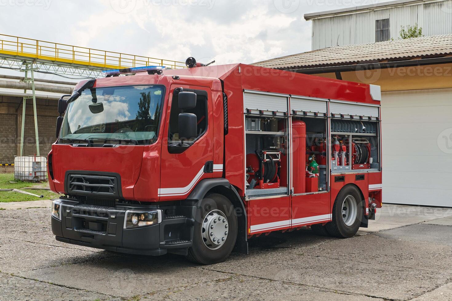 A state-of-the-art firetruck, equipped with advanced rescue technology, stands ready with its skilled firefighting team, prepared to intervene and respond rapidly to emergencies, ensuring the safety photo