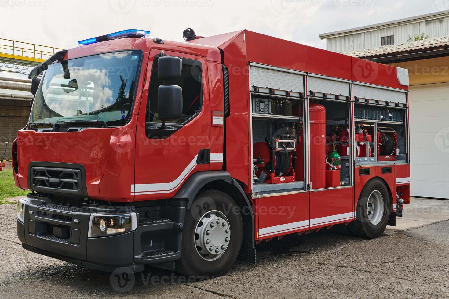A state-of-the-art firetruck, equipped with advanced rescue technology, stands ready with its skilled firefighting team, prepared to intervene and respond rapidly to emergencies, ensuring the safety photo