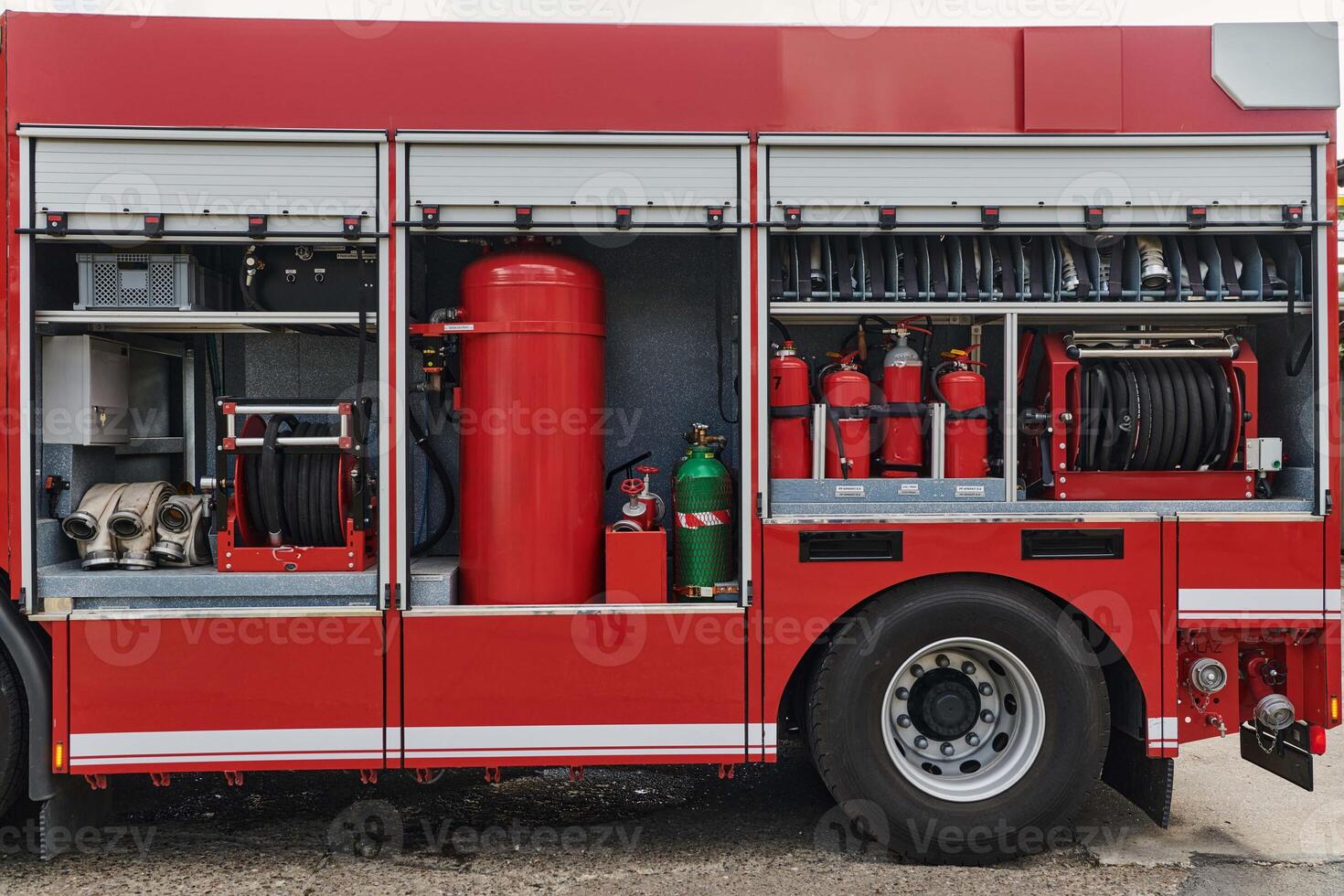 A state-of-the-art firetruck, equipped with advanced rescue technology, stands ready with its skilled firefighting team, prepared to intervene and respond rapidly to emergencies, ensuring the safety photo