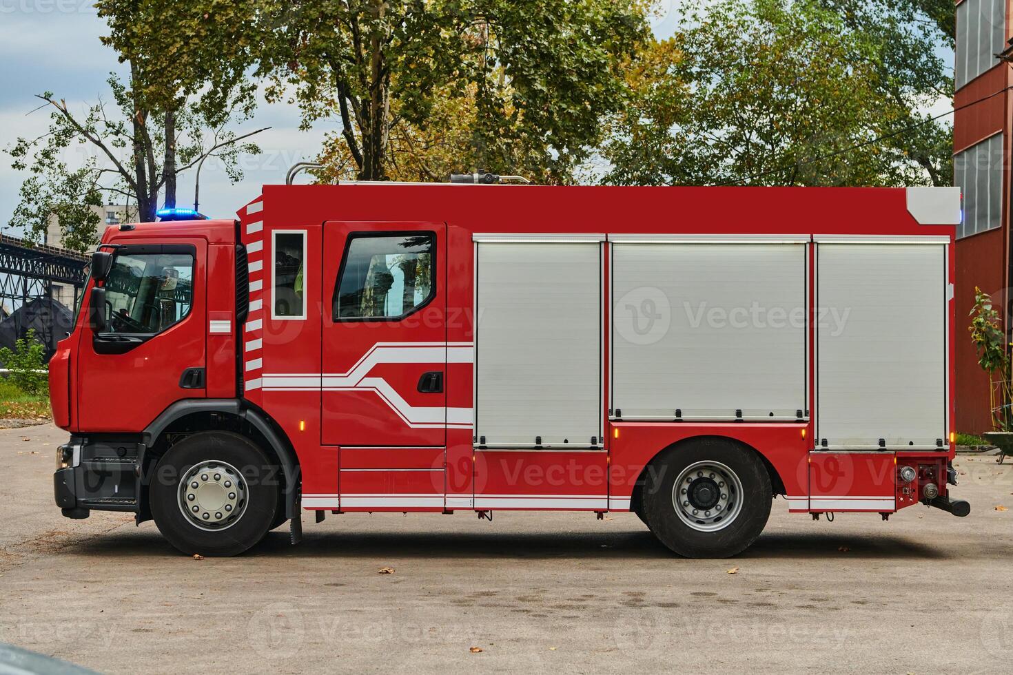 A state-of-the-art firetruck, equipped with advanced rescue technology, stands ready with its skilled firefighting team, prepared to intervene and respond rapidly to emergencies, ensuring the safety photo