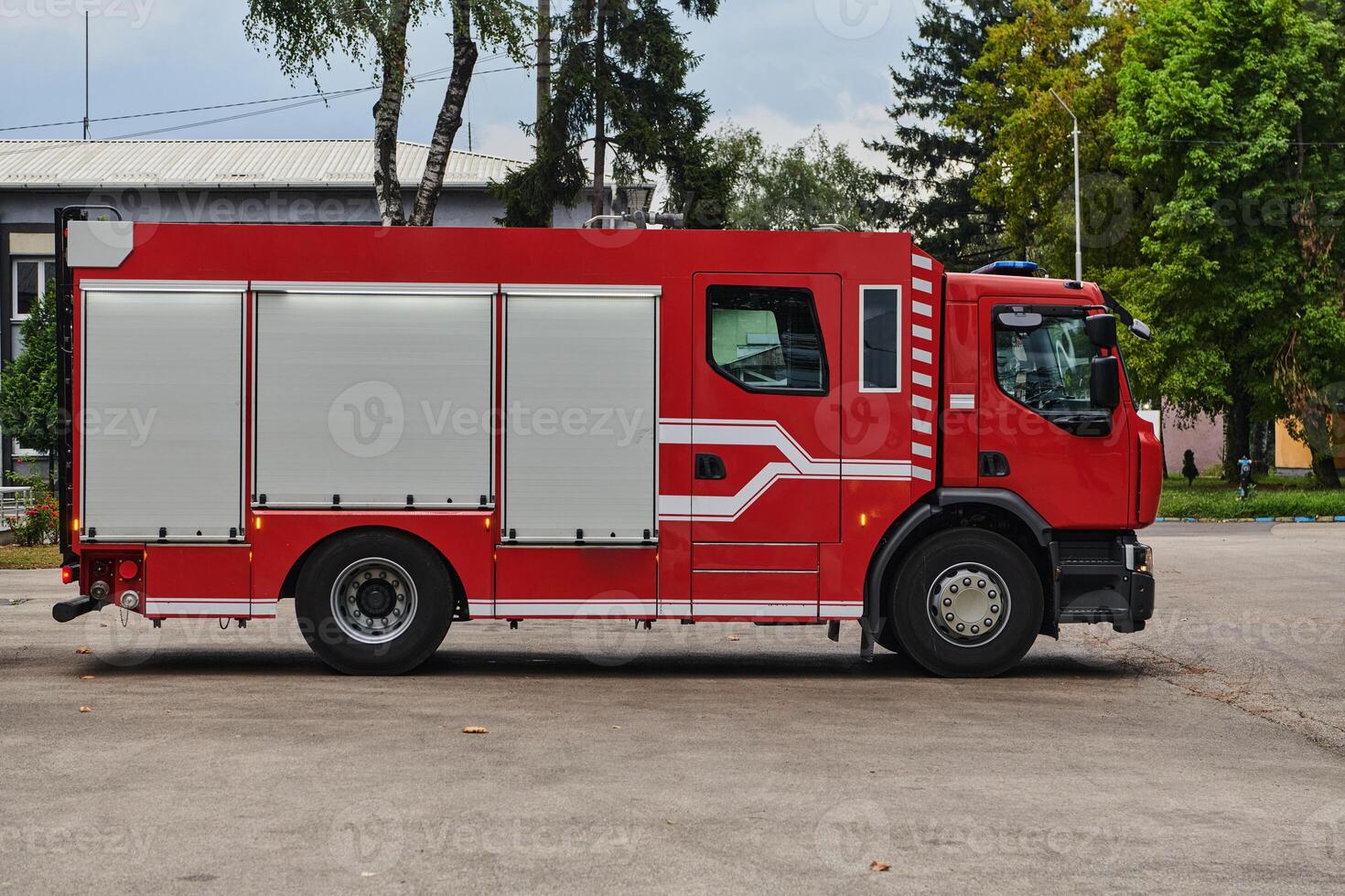 A state-of-the-art firetruck, equipped with advanced rescue technology, stands ready with its skilled firefighting team, prepared to intervene and respond rapidly to emergencies, ensuring the safety photo