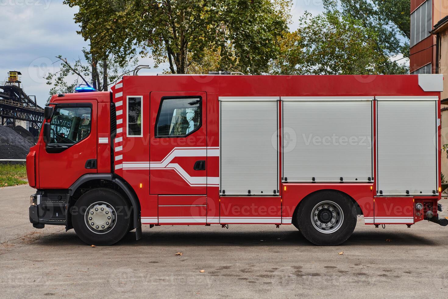 A state-of-the-art firetruck, equipped with advanced rescue technology, stands ready with its skilled firefighting team, prepared to intervene and respond rapidly to emergencies, ensuring the safety photo