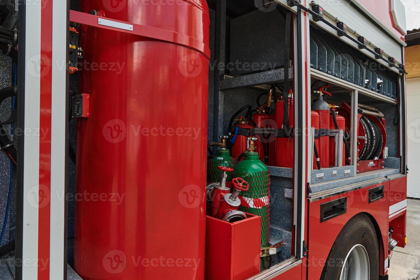 A state-of-the-art firetruck, equipped with advanced rescue technology, stands ready with its skilled firefighting team, prepared to intervene and respond rapidly to emergencies, ensuring the safety photo