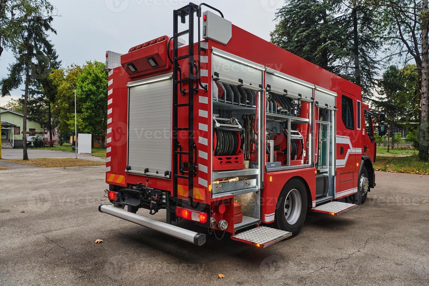 A state-of-the-art firetruck, equipped with advanced rescue technology, stands ready with its skilled firefighting team, prepared to intervene and respond rapidly to emergencies, ensuring the safety photo