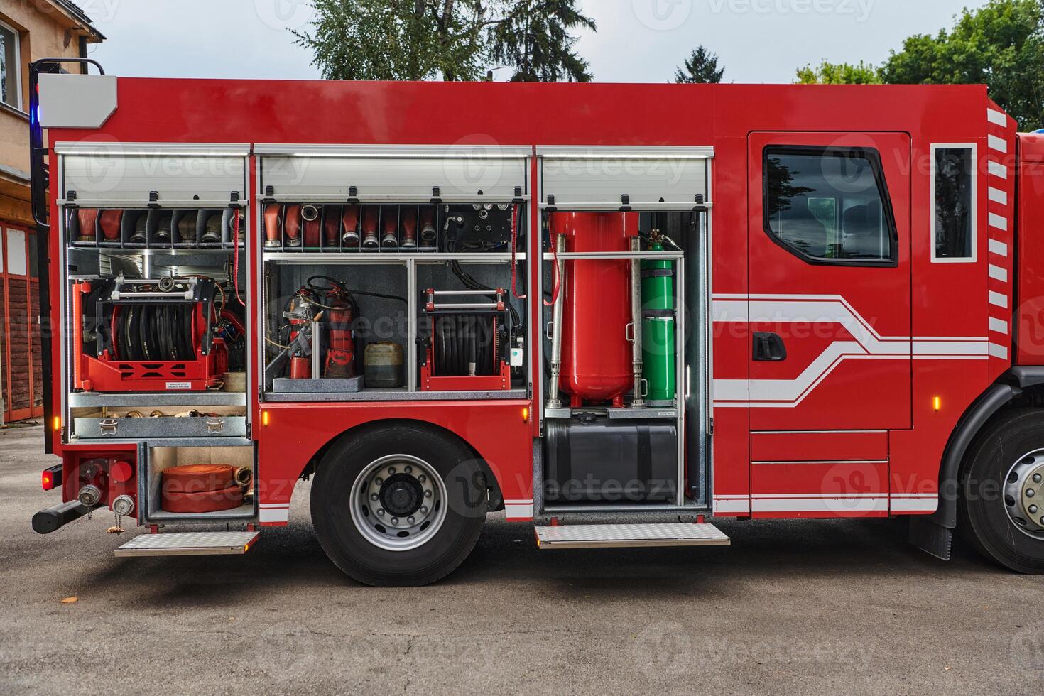 A state-of-the-art firetruck, equipped with advanced rescue technology, stands ready with its skilled firefighting team, prepared to intervene and respond rapidly to emergencies, ensuring the safety photo
