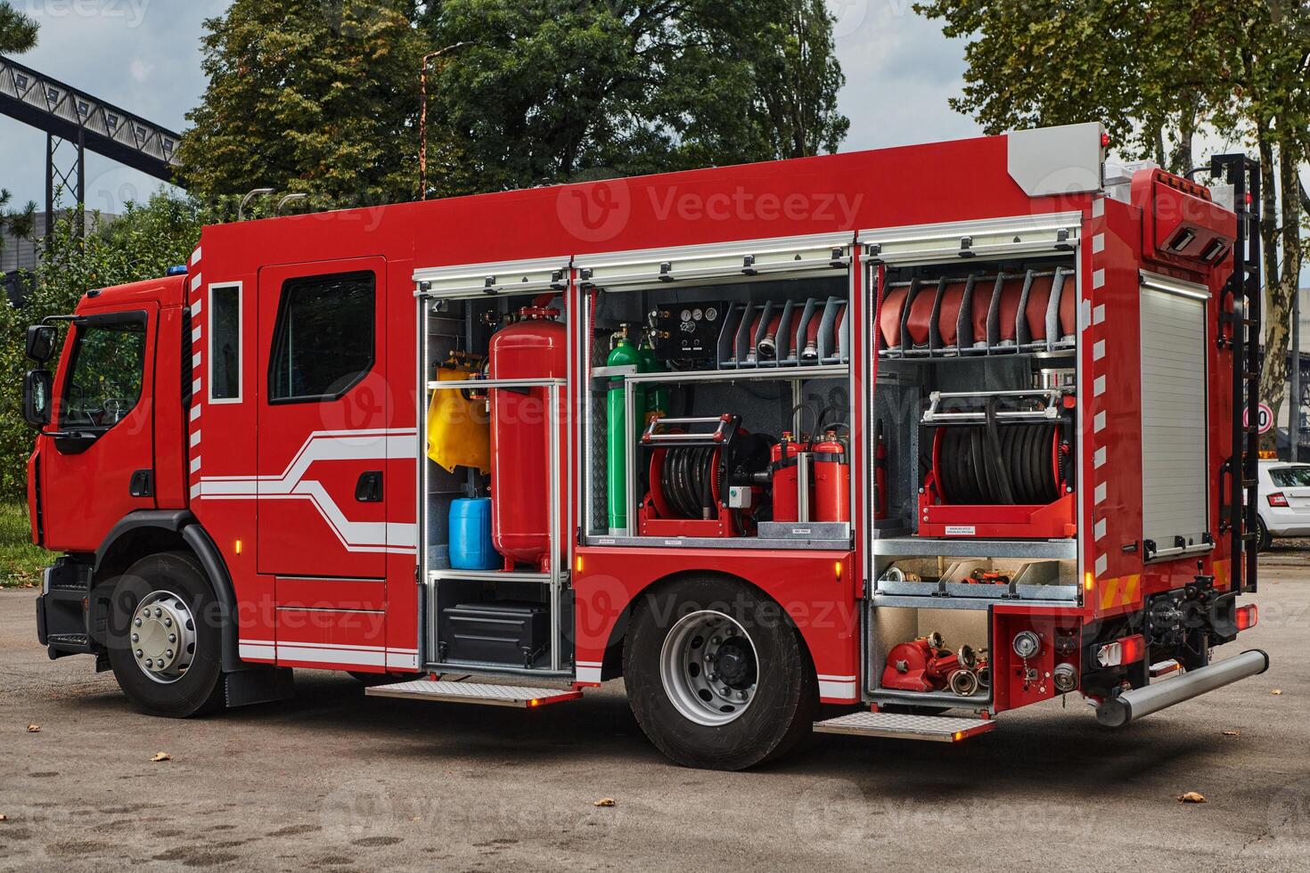 A state-of-the-art firetruck, equipped with advanced rescue technology, stands ready with its skilled firefighting team, prepared to intervene and respond rapidly to emergencies, ensuring the safety photo