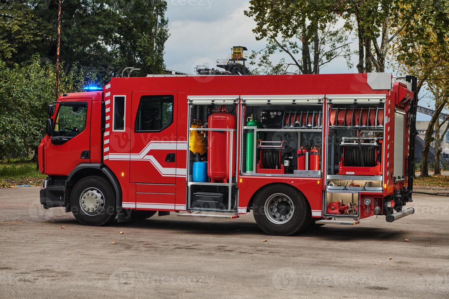A state-of-the-art firetruck, equipped with advanced rescue technology, stands ready with its skilled firefighting team, prepared to intervene and respond rapidly to emergencies, ensuring the safety photo